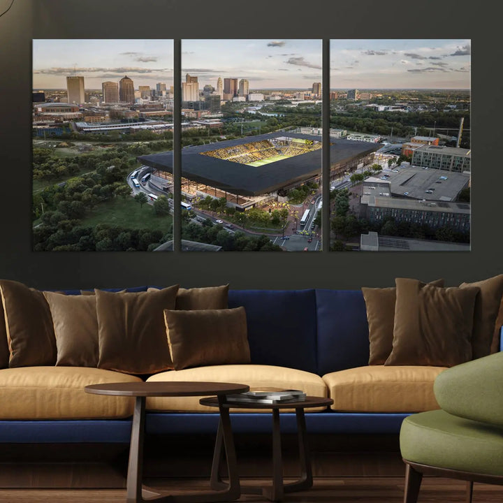 A living room is adorned with the Columbus Crew Soccer Team Print, showcasing a triptych of Columbus Crew Stadium and cityscape on museum-quality canvas. The high-resolution printing ensures vivid detail, while a UV-protective coating preserves its brilliance.