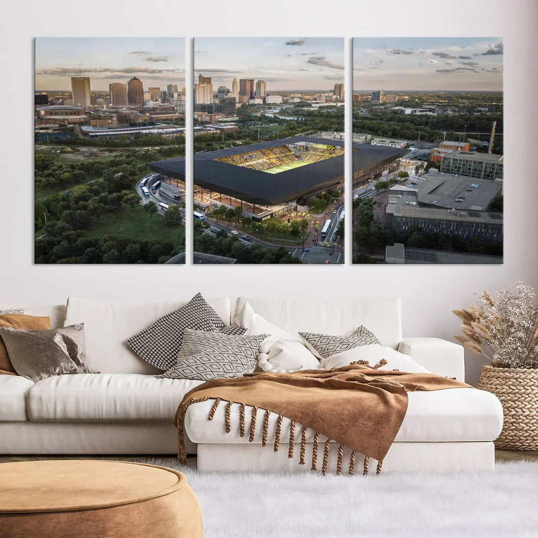 A living room is adorned with the Columbus Crew Soccer Team Print, showcasing a triptych of Columbus Crew Stadium and cityscape on museum-quality canvas. The high-resolution printing ensures vivid detail, while a UV-protective coating preserves its brilliance.