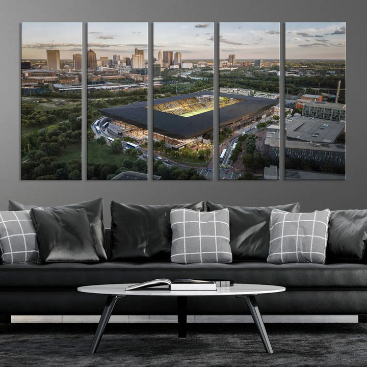 A living room is adorned with the Columbus Crew Soccer Team Print, showcasing a triptych of Columbus Crew Stadium and cityscape on museum-quality canvas. The high-resolution printing ensures vivid detail, while a UV-protective coating preserves its brilliance.