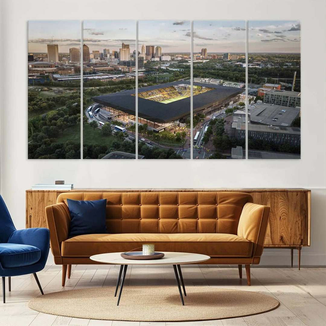 A living room is adorned with the Columbus Crew Soccer Team Print, showcasing a triptych of Columbus Crew Stadium and cityscape on museum-quality canvas. The high-resolution printing ensures vivid detail, while a UV-protective coating preserves its brilliance.