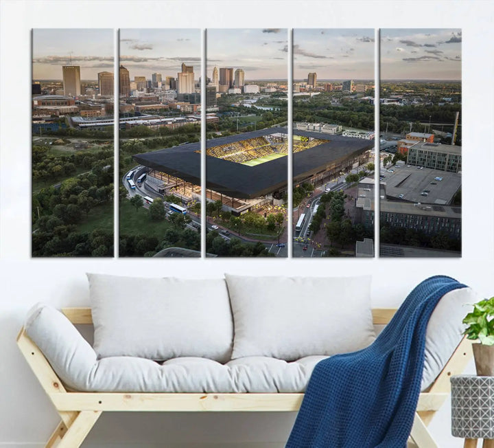 A living room is adorned with the Columbus Crew Soccer Team Print, showcasing a triptych of Columbus Crew Stadium and cityscape on museum-quality canvas. The high-resolution printing ensures vivid detail, while a UV-protective coating preserves its brilliance.