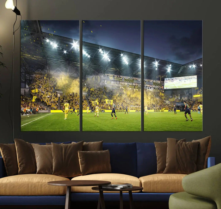 The Columbus Crew Stadium Match Triple Canvas Wall Art, featuring a dynamic MLS game scene, captures the excitement of a thrilling soccer match with stadium lights illuminating the field and crowd.