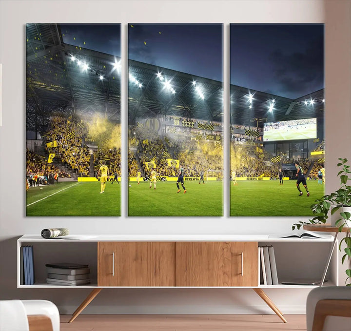 The Columbus Crew Stadium Match Triple Canvas Wall Art, featuring a dynamic MLS game scene, captures the excitement of a thrilling soccer match with stadium lights illuminating the field and crowd.