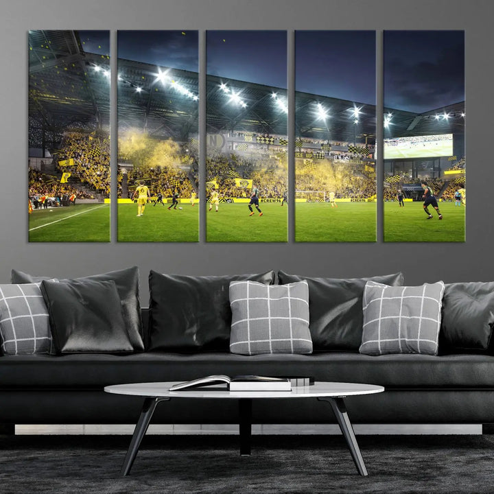 The Columbus Crew Stadium Match Triple Canvas Wall Art, featuring a dynamic MLS game scene, captures the excitement of a thrilling soccer match with stadium lights illuminating the field and crowd.