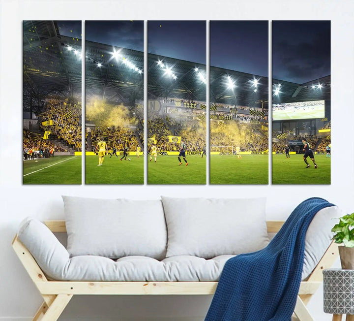 The Columbus Crew Stadium Match Triple Canvas Wall Art, featuring a dynamic MLS game scene, captures the excitement of a thrilling soccer match with stadium lights illuminating the field and crowd.