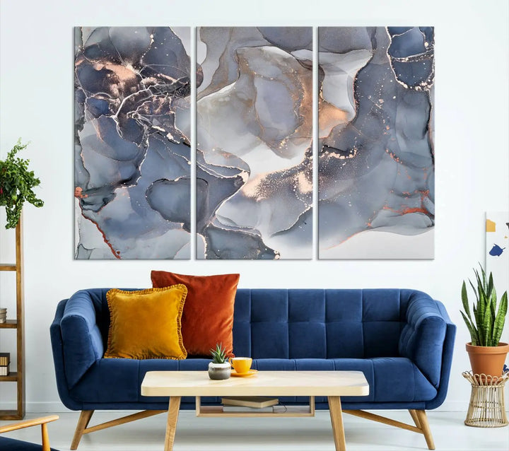 A Contemporary Art Gray Gold Abstract Canvas Art Print on museum-quality canvas adorns the modern living room.