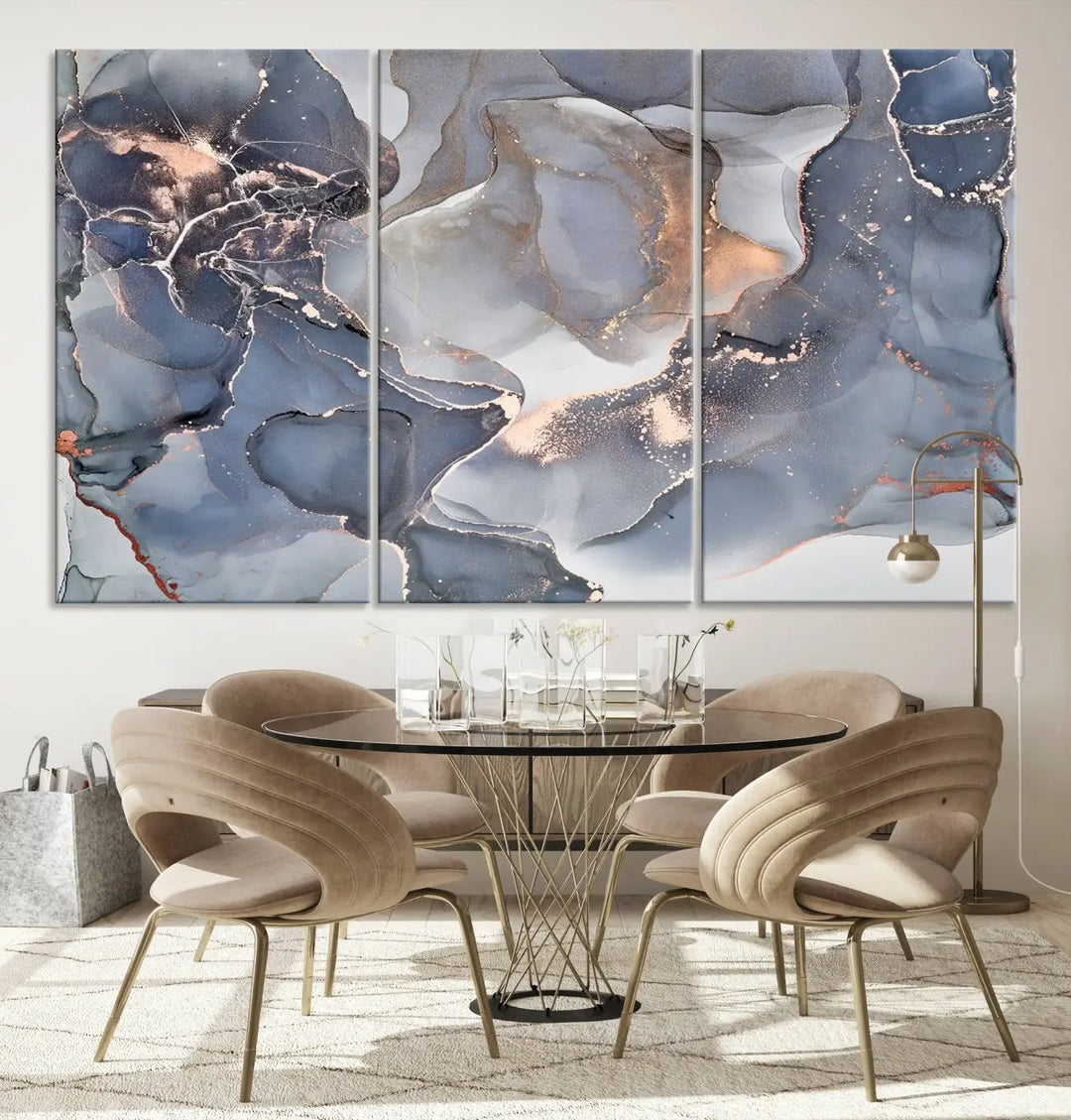 A Contemporary Art Gray Gold Abstract Canvas Art Print on museum-quality canvas adorns the modern living room.