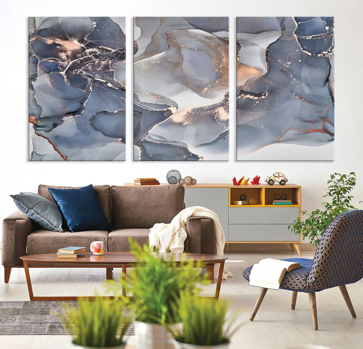 A Contemporary Art Gray Gold Abstract Canvas Art Print on museum-quality canvas adorns the modern living room.