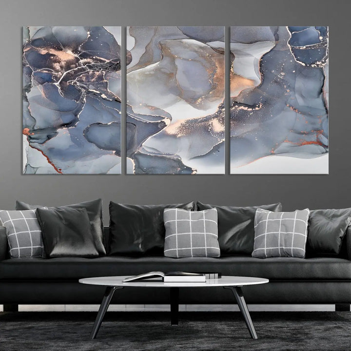 A Contemporary Art Gray Gold Abstract Canvas Art Print on museum-quality canvas adorns the modern living room.