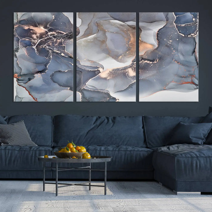 A Contemporary Art Gray Gold Abstract Canvas Art Print on museum-quality canvas adorns the modern living room.