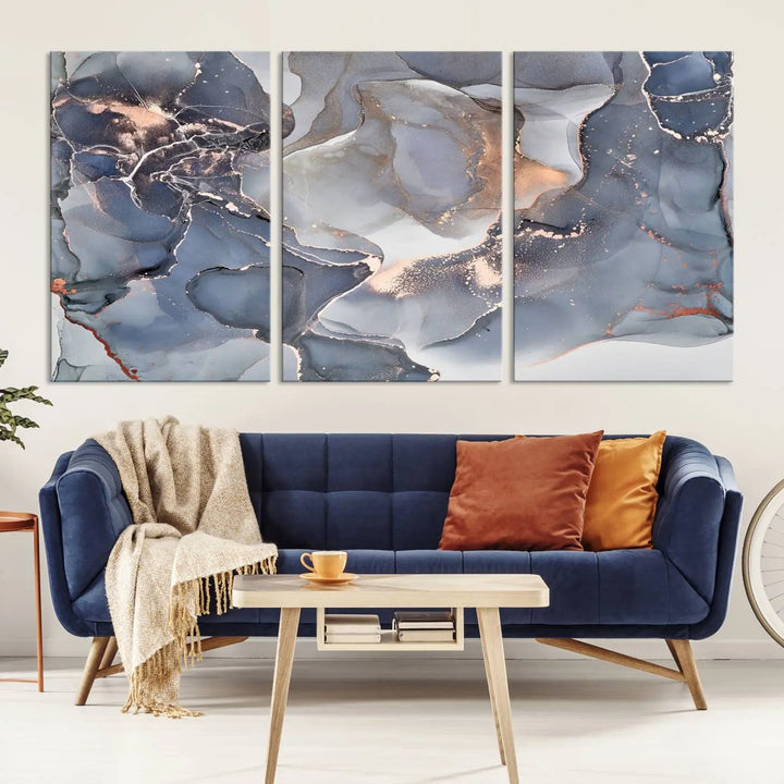 A Contemporary Art Gray Gold Abstract Canvas Art Print on museum-quality canvas adorns the modern living room.