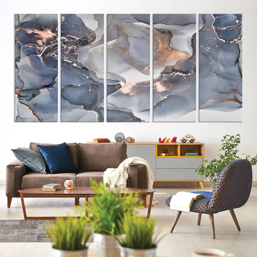 A Contemporary Art Gray Gold Abstract Canvas Art Print on museum-quality canvas adorns the modern living room.