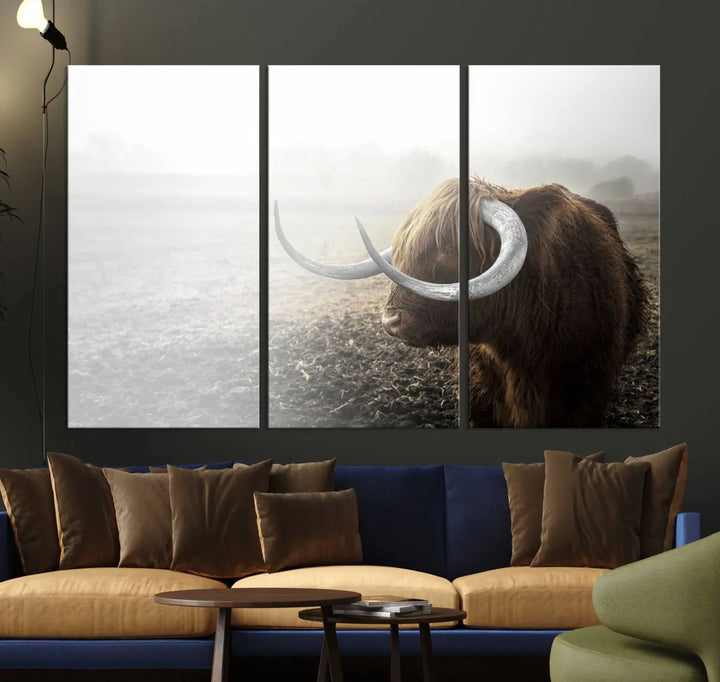 A captivating Cow Wall Art Canvas Print featuring a Highland cow with impressive horns in a misty field, crafted on museum-quality canvas. Its UV-protective coating preserves the artwork's vibrant colors.