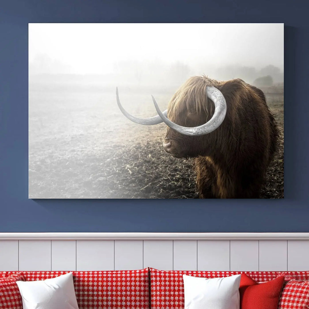 A captivating Cow Wall Art Canvas Print featuring a Highland cow with impressive horns in a misty field, crafted on museum-quality canvas. Its UV-protective coating preserves the artwork's vibrant colors.