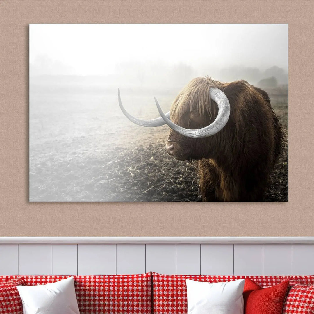 A captivating Cow Wall Art Canvas Print featuring a Highland cow with impressive horns in a misty field, crafted on museum-quality canvas. Its UV-protective coating preserves the artwork's vibrant colors.