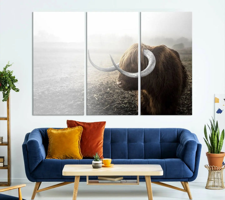 A captivating Cow Wall Art Canvas Print featuring a Highland cow with impressive horns in a misty field, crafted on museum-quality canvas. Its UV-protective coating preserves the artwork's vibrant colors.