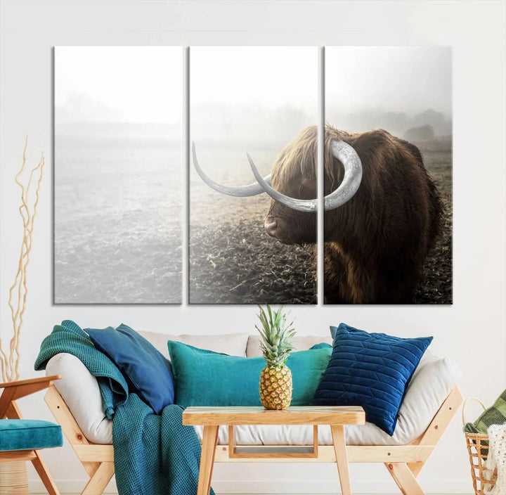 A captivating Cow Wall Art Canvas Print featuring a Highland cow with impressive horns in a misty field, crafted on museum-quality canvas. Its UV-protective coating preserves the artwork's vibrant colors.