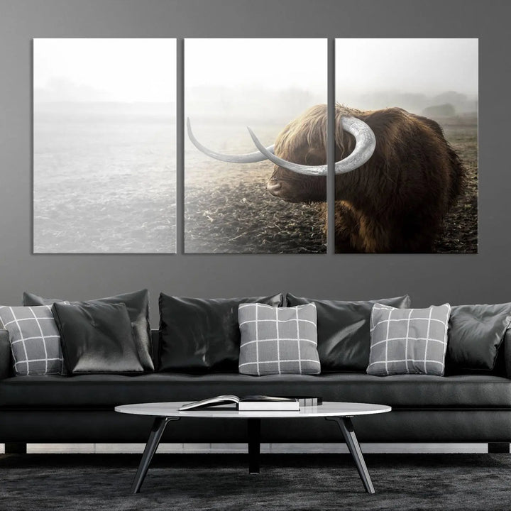 A captivating Cow Wall Art Canvas Print featuring a Highland cow with impressive horns in a misty field, crafted on museum-quality canvas. Its UV-protective coating preserves the artwork's vibrant colors.