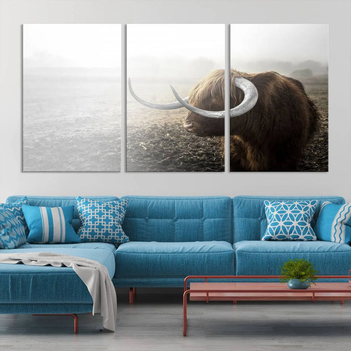 A captivating Cow Wall Art Canvas Print featuring a Highland cow with impressive horns in a misty field, crafted on museum-quality canvas. Its UV-protective coating preserves the artwork's vibrant colors.