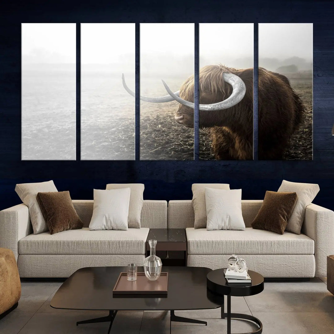 A captivating Cow Wall Art Canvas Print featuring a Highland cow with impressive horns in a misty field, crafted on museum-quality canvas. Its UV-protective coating preserves the artwork's vibrant colors.