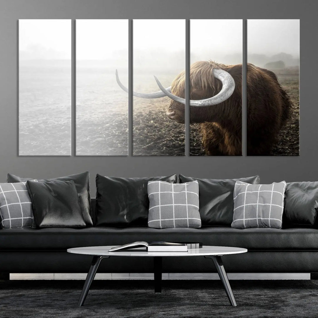 A captivating Cow Wall Art Canvas Print featuring a Highland cow with impressive horns in a misty field, crafted on museum-quality canvas. Its UV-protective coating preserves the artwork's vibrant colors.