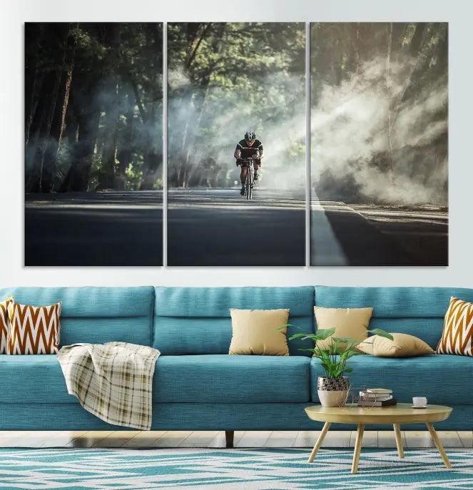 A cyclist rides through a misty forest in the "Cycling Road Bike in the Morning" artwork, divided into three panels on gallery-wrapped, museum-quality canvas.