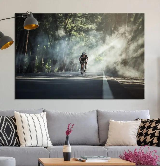 A cyclist rides through a misty forest in the "Cycling Road Bike in the Morning" artwork, divided into three panels on gallery-wrapped, museum-quality canvas.