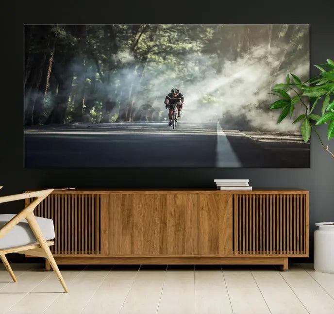 A cyclist rides through a misty forest in the "Cycling Road Bike in the Morning" artwork, divided into three panels on gallery-wrapped, museum-quality canvas.