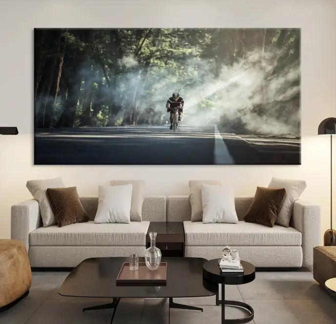 A cyclist rides through a misty forest in the "Cycling Road Bike in the Morning" artwork, divided into three panels on gallery-wrapped, museum-quality canvas.