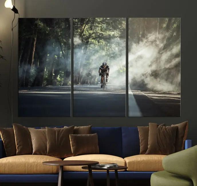 A cyclist rides through a misty forest in the "Cycling Road Bike in the Morning" artwork, divided into three panels on gallery-wrapped, museum-quality canvas.