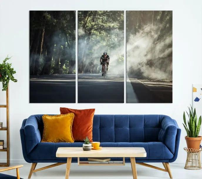 A cyclist rides through a misty forest in the "Cycling Road Bike in the Morning" artwork, divided into three panels on gallery-wrapped, museum-quality canvas.