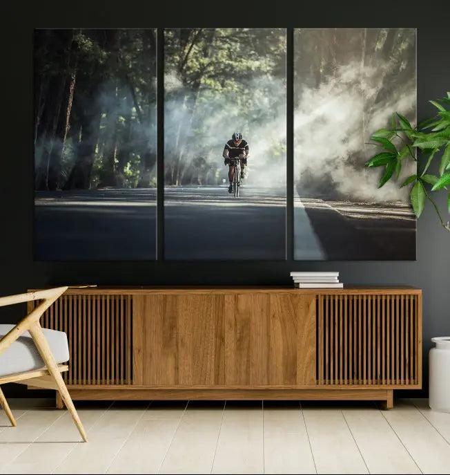 A cyclist rides through a misty forest in the "Cycling Road Bike in the Morning" artwork, divided into three panels on gallery-wrapped, museum-quality canvas.