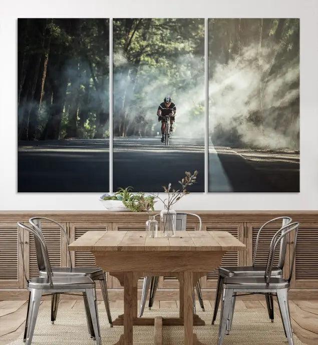 A cyclist rides through a misty forest in the "Cycling Road Bike in the Morning" artwork, divided into three panels on gallery-wrapped, museum-quality canvas.