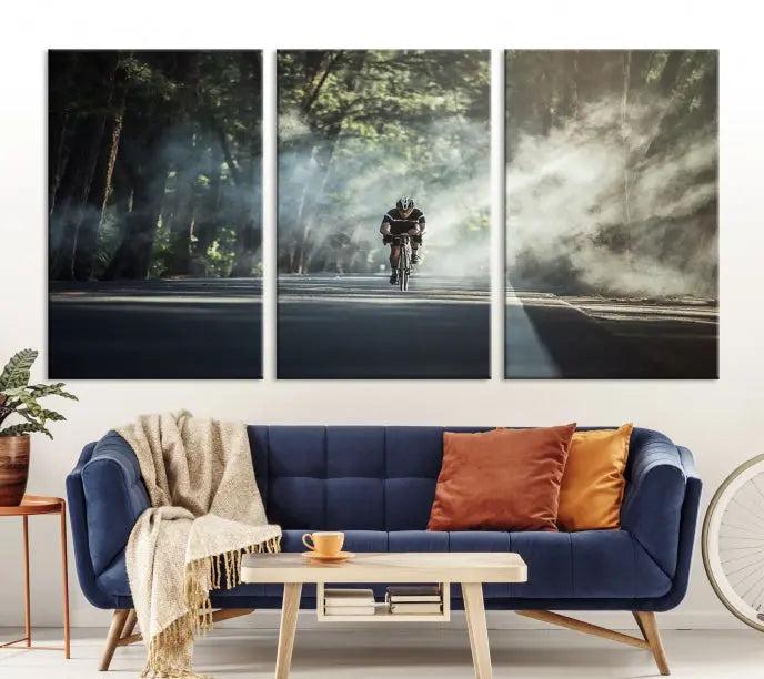 A cyclist rides through a misty forest in the "Cycling Road Bike in the Morning" artwork, divided into three panels on gallery-wrapped, museum-quality canvas.