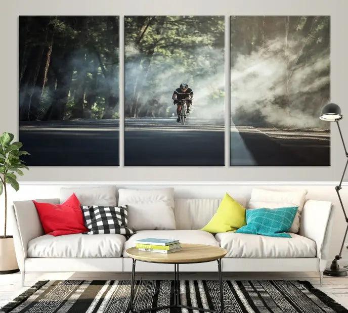 A cyclist rides through a misty forest in the "Cycling Road Bike in the Morning" artwork, divided into three panels on gallery-wrapped, museum-quality canvas.