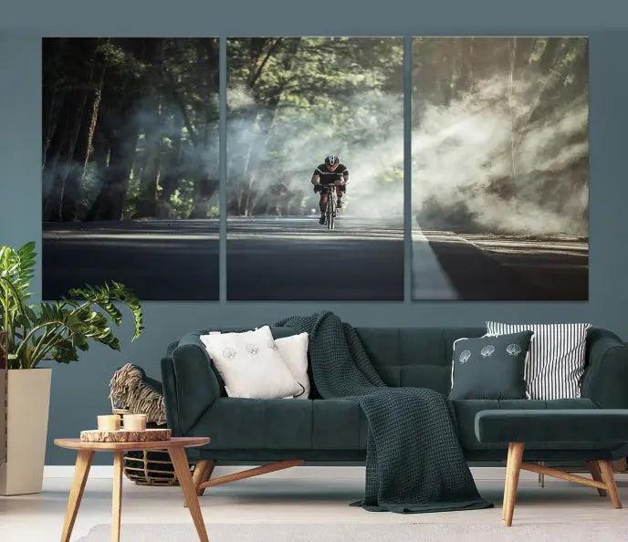 A cyclist rides through a misty forest in the "Cycling Road Bike in the Morning" artwork, divided into three panels on gallery-wrapped, museum-quality canvas.