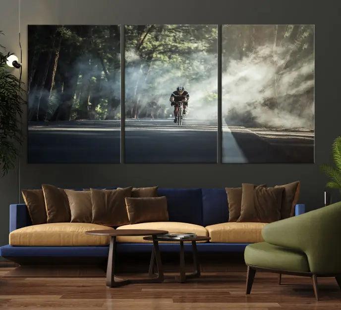 A cyclist rides through a misty forest in the "Cycling Road Bike in the Morning" artwork, divided into three panels on gallery-wrapped, museum-quality canvas.