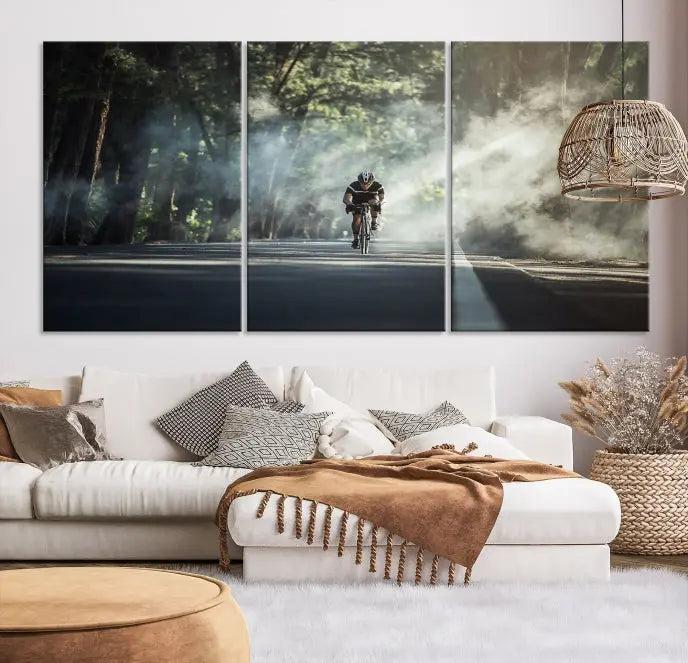 A cyclist rides through a misty forest in the "Cycling Road Bike in the Morning" artwork, divided into three panels on gallery-wrapped, museum-quality canvas.