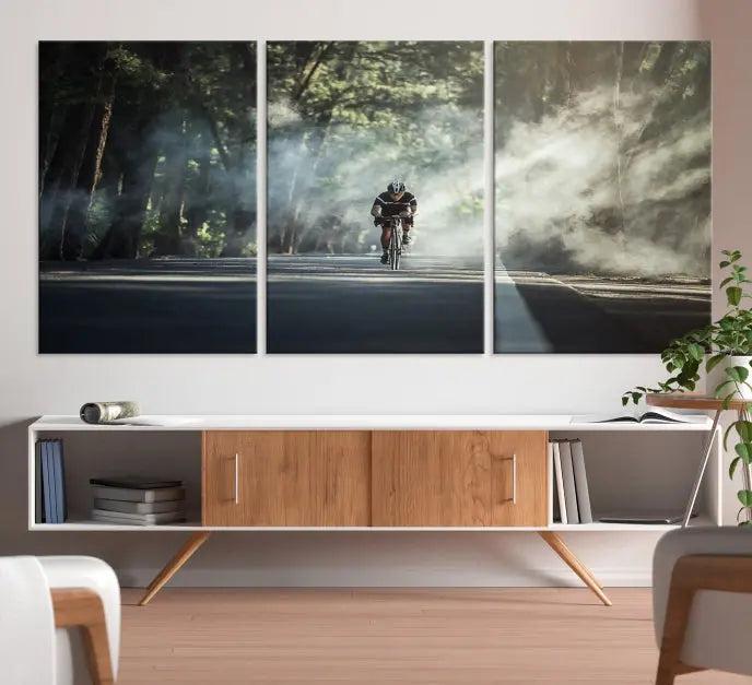 A cyclist rides through a misty forest in the "Cycling Road Bike in the Morning" artwork, divided into three panels on gallery-wrapped, museum-quality canvas.