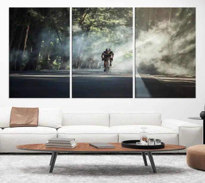 A cyclist rides through a misty forest in the "Cycling Road Bike in the Morning" artwork, divided into three panels on gallery-wrapped, museum-quality canvas.