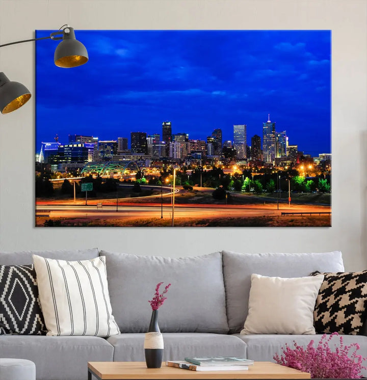 An inviting room features the "Dallas City Lights Night Bright Blue Skyline Cityscape View Wall Art Canvas Print," elegantly suspended and basking in soft lighting.