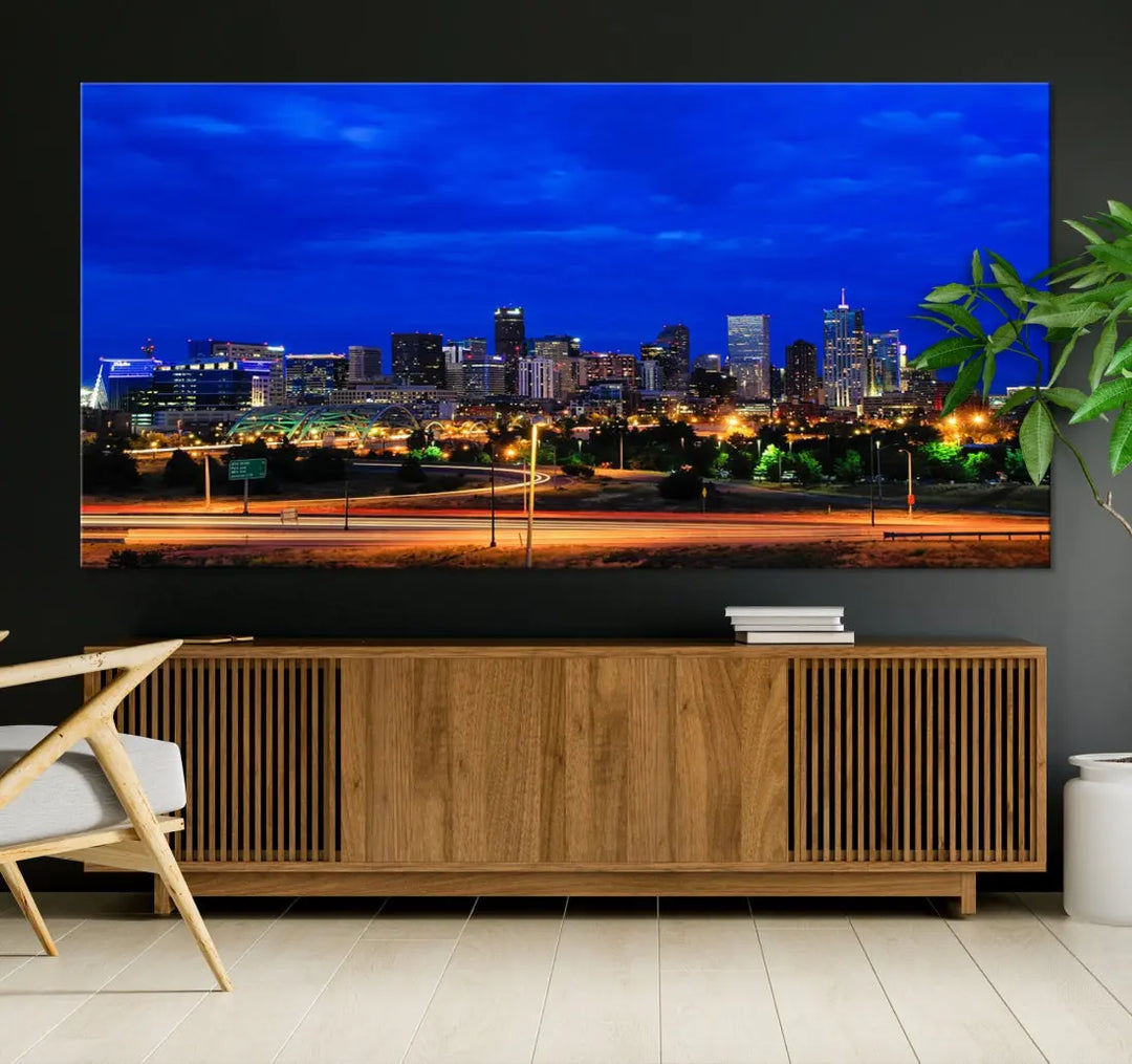 An inviting room features the "Dallas City Lights Night Bright Blue Skyline Cityscape View Wall Art Canvas Print," elegantly suspended and basking in soft lighting.