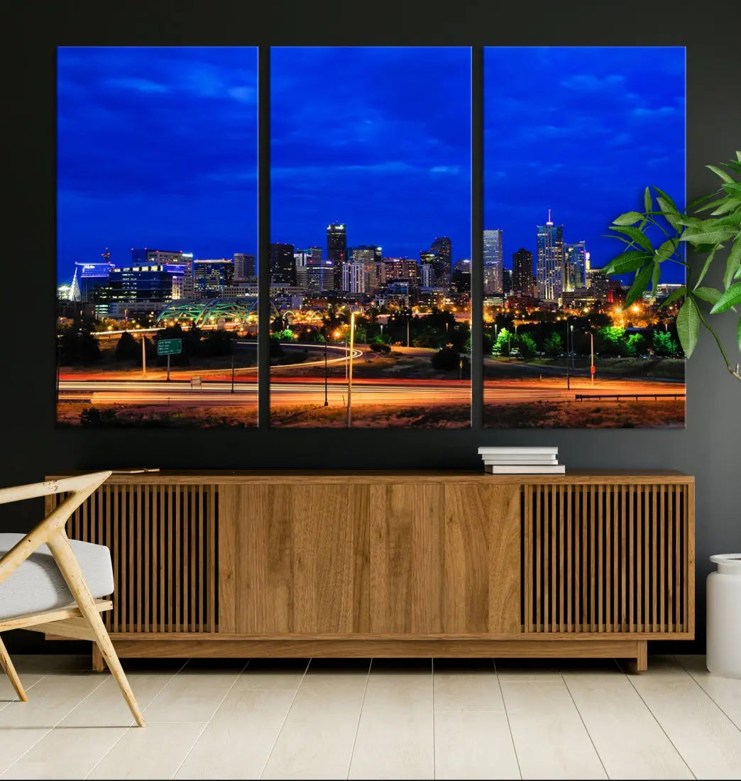 An inviting room features the "Dallas City Lights Night Bright Blue Skyline Cityscape View Wall Art Canvas Print," elegantly suspended and basking in soft lighting.