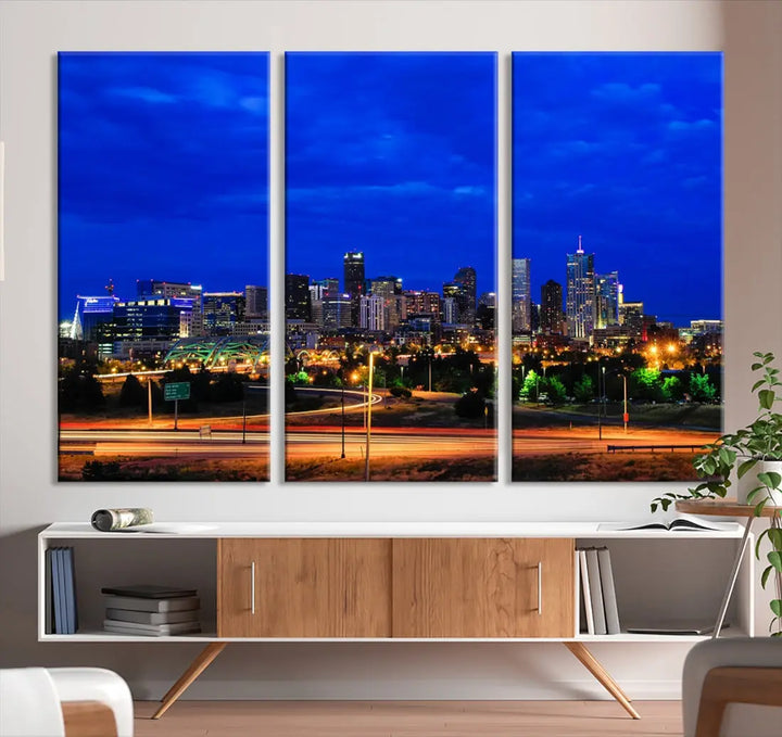 An inviting room features the "Dallas City Lights Night Bright Blue Skyline Cityscape View Wall Art Canvas Print," elegantly suspended and basking in soft lighting.