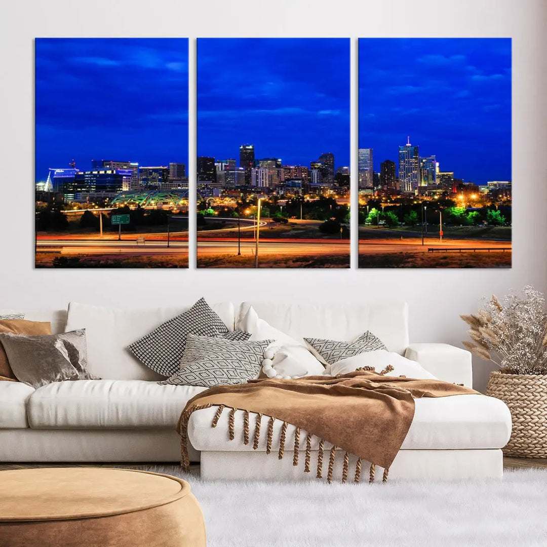 An inviting room features the "Dallas City Lights Night Bright Blue Skyline Cityscape View Wall Art Canvas Print," elegantly suspended and basking in soft lighting.