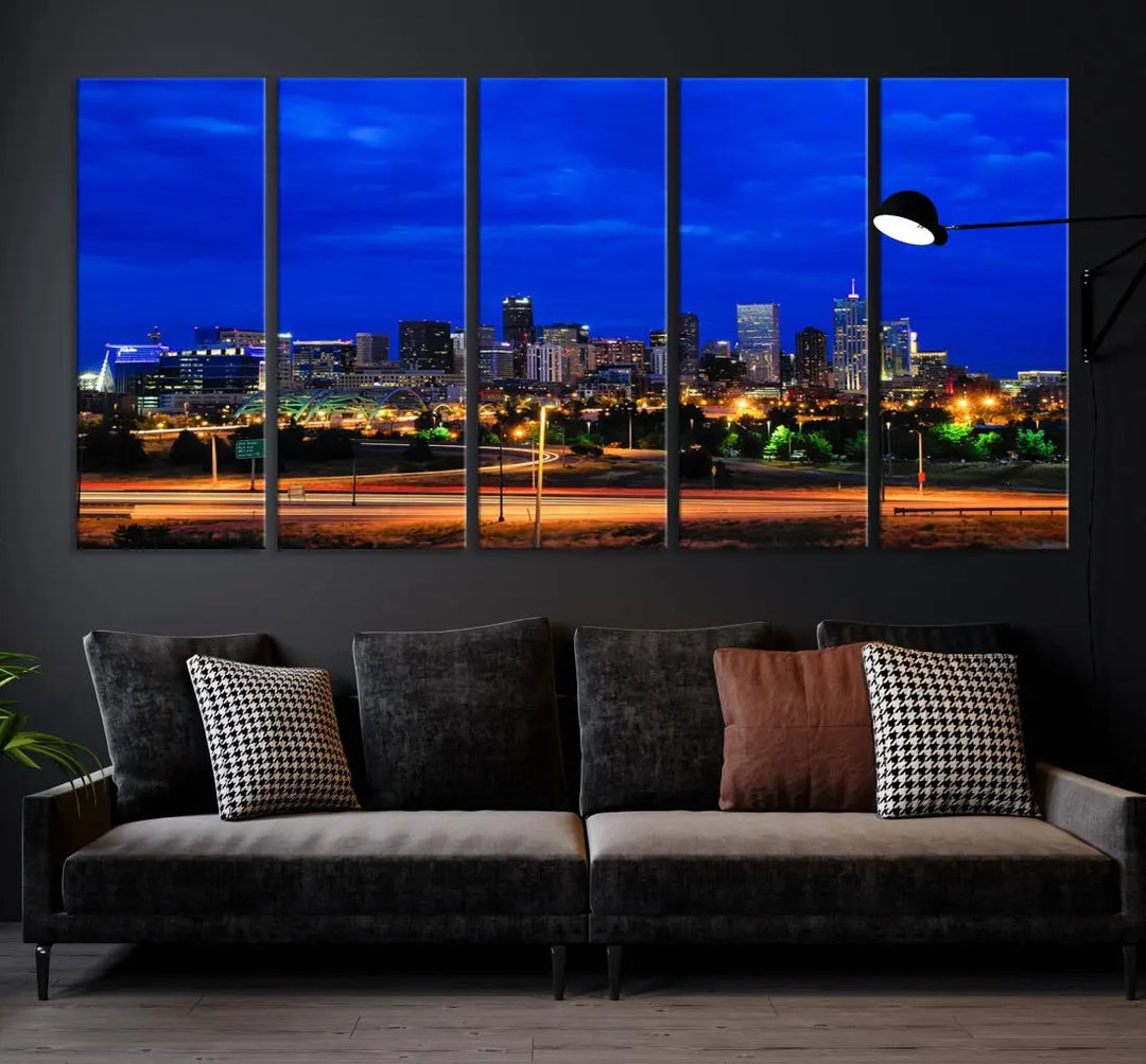 An inviting room features the "Dallas City Lights Night Bright Blue Skyline Cityscape View Wall Art Canvas Print," elegantly suspended and basking in soft lighting.