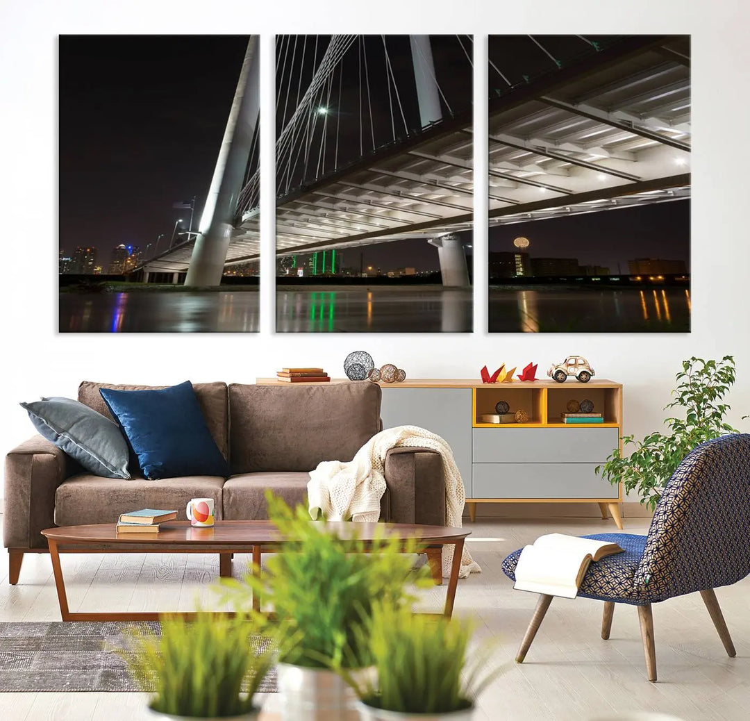 A modern living room showcases the "Dallas City Lights" night skyline cityscape as a triptych on museum-quality canvas. Enjoy the art's longevity with its UV-protective coating, all available with free shipping.