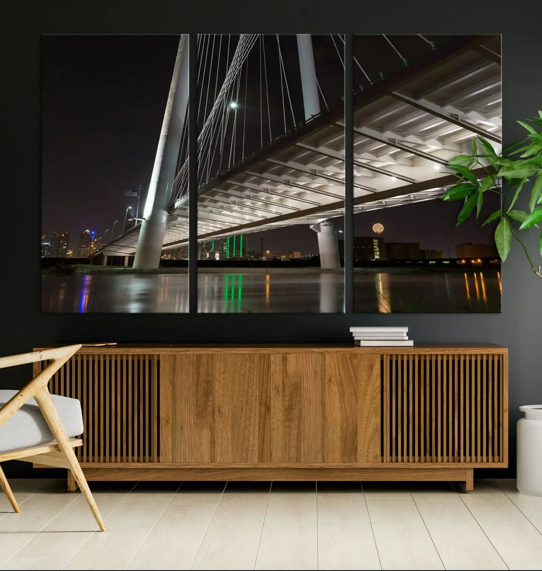 A modern living room showcases the "Dallas City Lights" night skyline cityscape as a triptych on museum-quality canvas. Enjoy the art's longevity with its UV-protective coating, all available with free shipping.