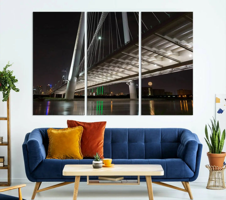 A modern living room showcases the "Dallas City Lights" night skyline cityscape as a triptych on museum-quality canvas. Enjoy the art's longevity with its UV-protective coating, all available with free shipping.