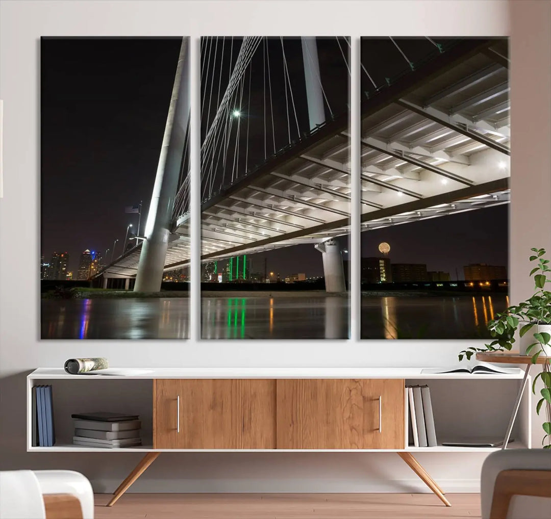 A modern living room showcases the "Dallas City Lights" night skyline cityscape as a triptych on museum-quality canvas. Enjoy the art's longevity with its UV-protective coating, all available with free shipping.